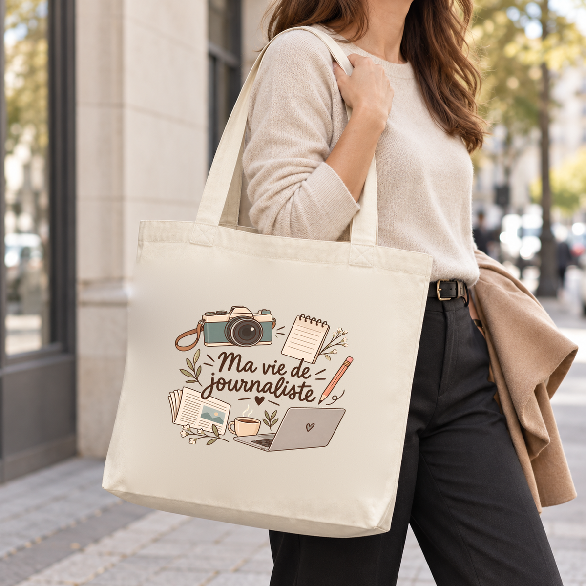 Tote bag journaliste « Ma vie de journaliste » Premium porté à l'épaule dans la rue, une veste sur le bras