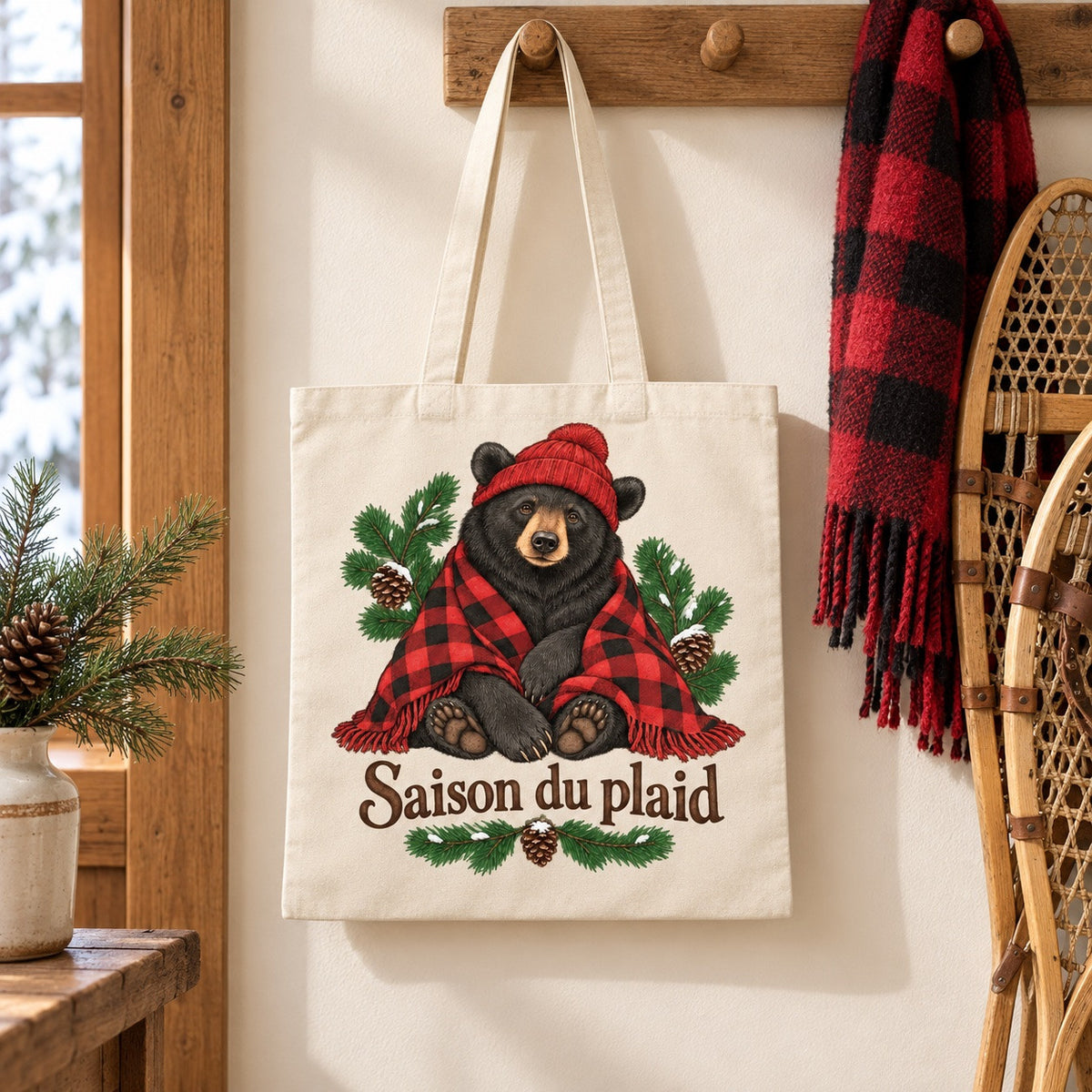 Tote bag « Saison du plaid » Essentiel suspendu près d'une paire de raquettes