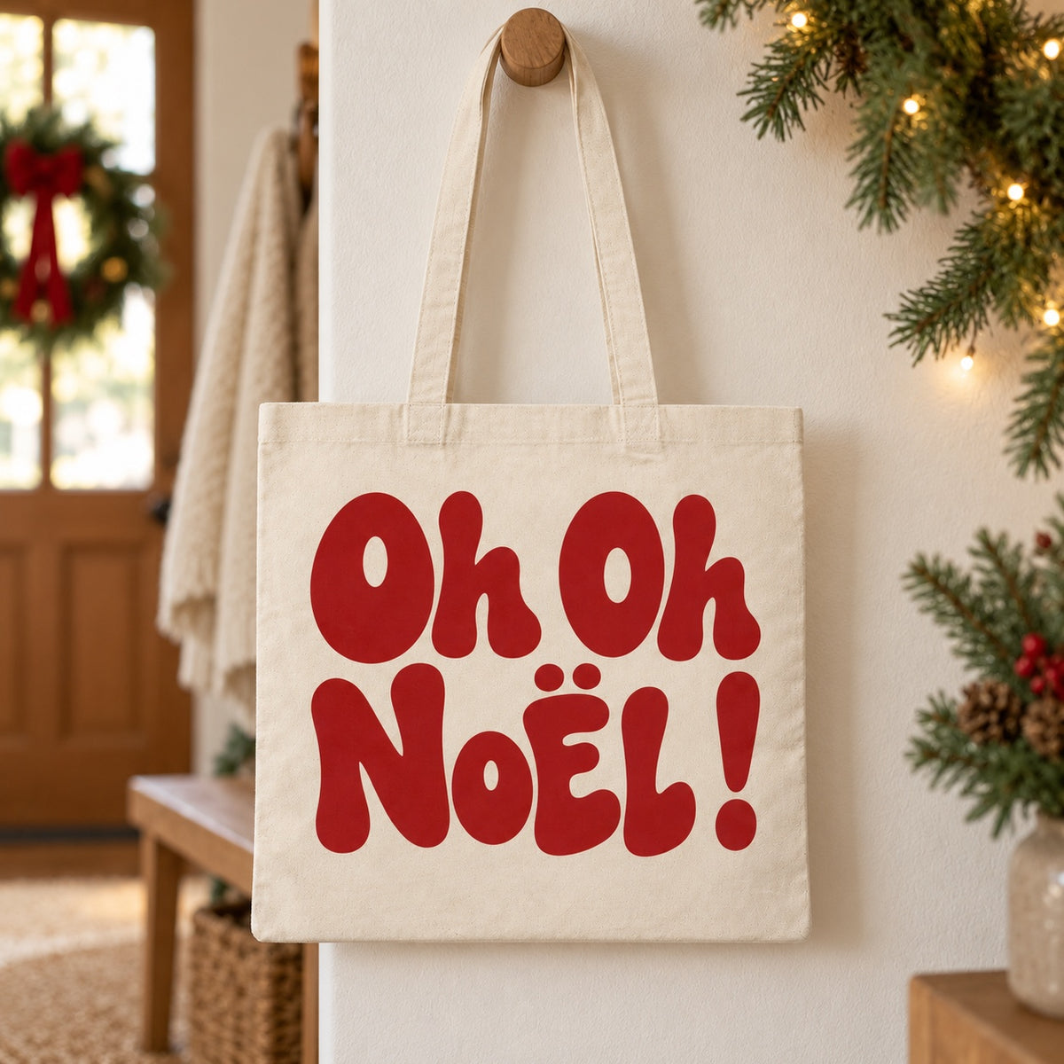 Tote bag de Noël « Oh oh Noël ! » Essentiel suspendu à une patère dans une entrée décorée pour Noël