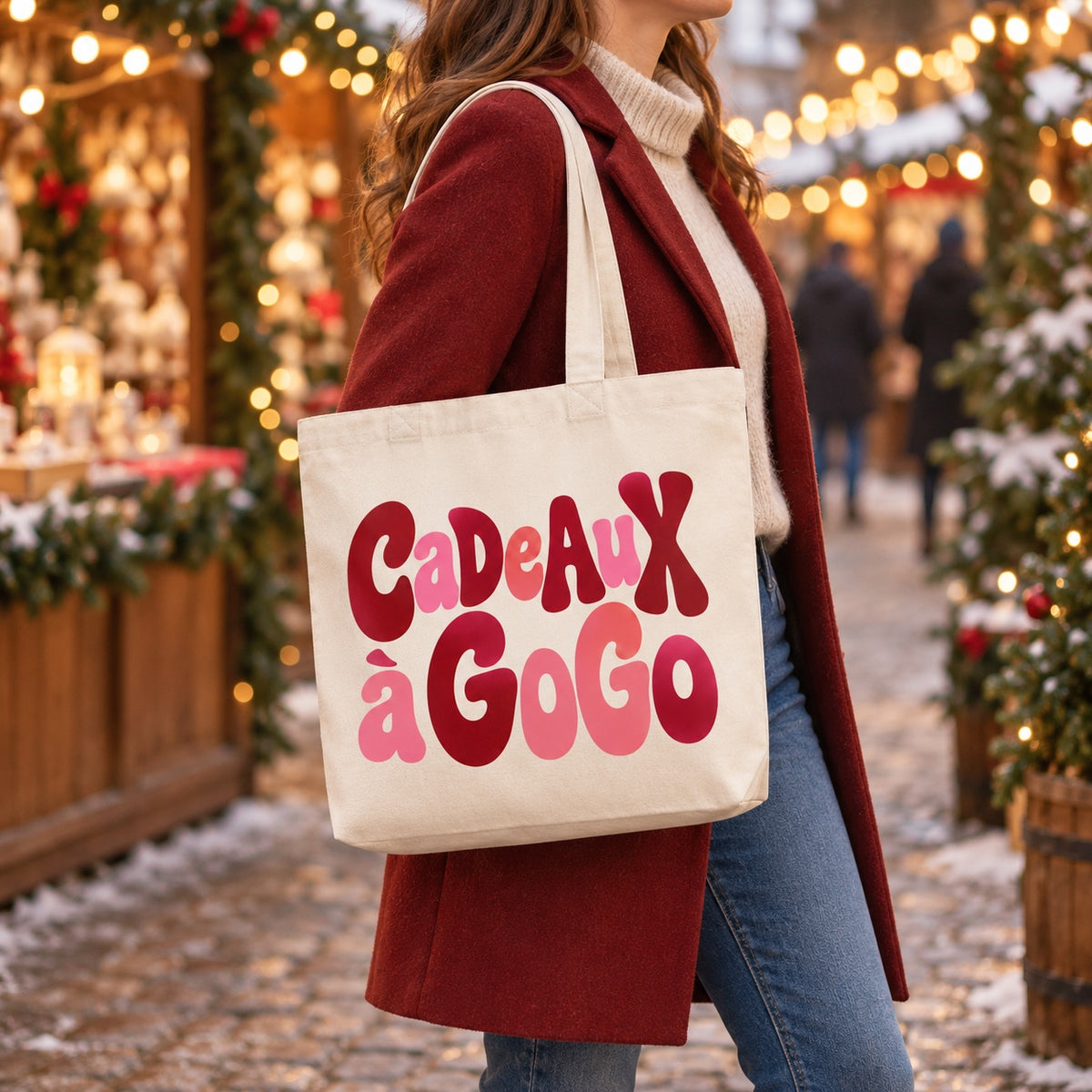 Tote bag de Noël « Cadeaux à gogo » Premium porté à l'épaule dans un marché de Noël