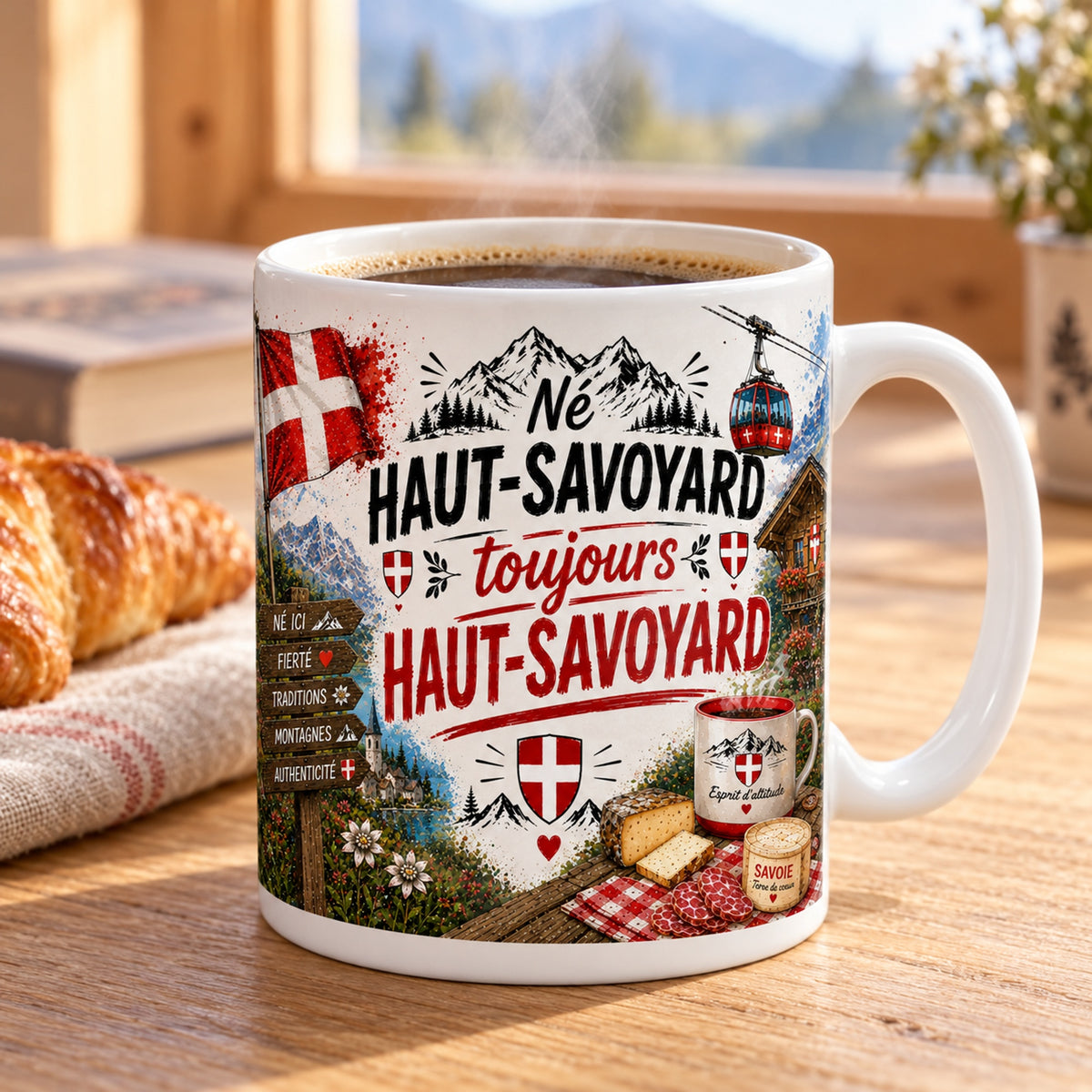 Mug Né Haut-Savoyard, Toujours Haut-Savoyard « Esprit d'Altitude » posé sur une table en bois avec un croissant, pause café