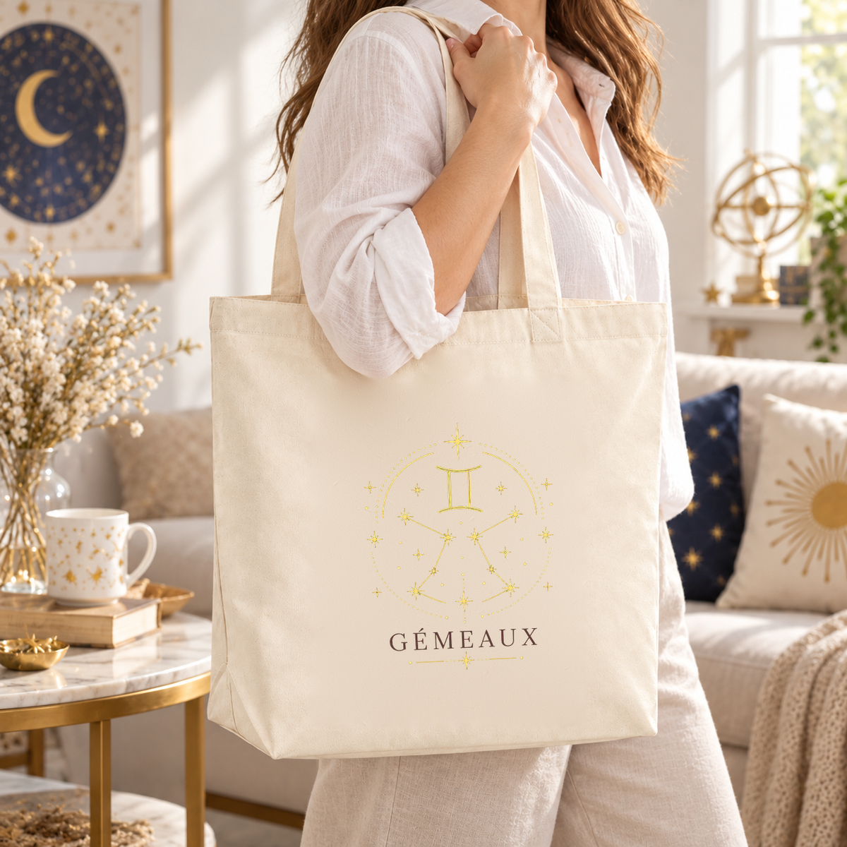 Tote bag signe astrologique « GÉMEAUX » Premium porté à l'épaule dans un salon lumineux à la décoration céleste