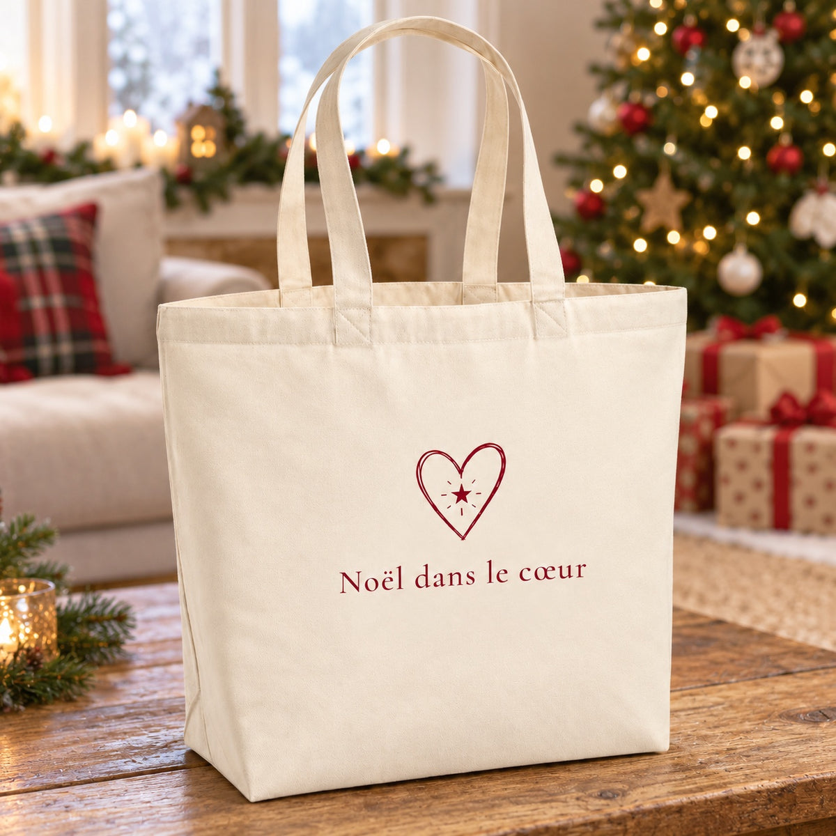 Tote bag de Noël « Noël dans le cœur » Premium posé sur une table de salon devant le sapin
